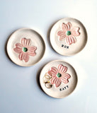 porcelain ring dish with pink dogwood stamped, with personalized name stamped in black