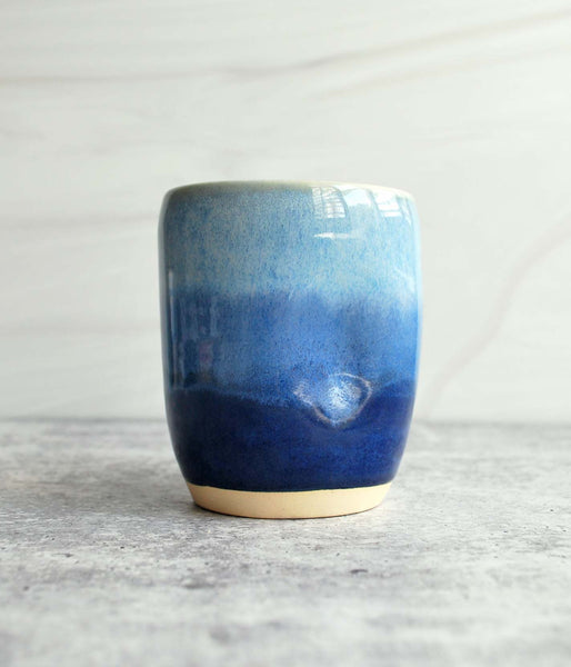 Ceramic tumbler with dark blue bottom and light blue top