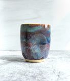 Ceramic tumbler with purple glaze on bottom and green on top
