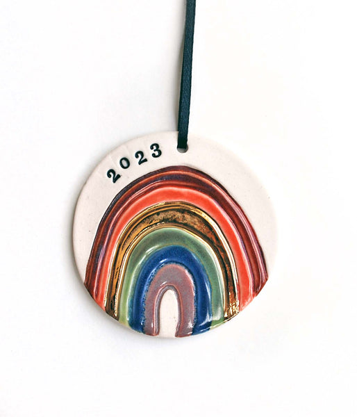 Rainbow OrnamentHandmade rainbow ornament with 22k gold or silver luster details, hand stamped with a date or name of your choosing (or left blank). A perfect family ornament for 20