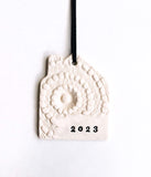 2023 House OrnamentHome shaped white lace ornament, hand stamped with 2023. Perfect to commemorate your new home, or a great gift for a loved one. 