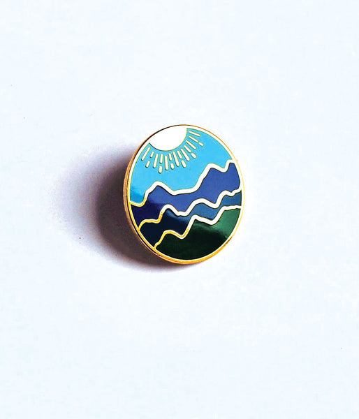 Blue Ridge Mountain Enamel PinBlue Ridge Mountain hard enamel cloisonné pin. This high-polished pin has a sky blue background, with different shades of blue and green for the mountains, and gold 