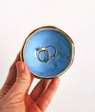Tiny Gold Ring Dish - Pinch Pot BowlStore your rings and jewelry in style with this pretty round ceramic ring dish, in the color of your choice, with 22k gold luster accents. Pair with a ring to make a