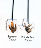 State Cactus Ornament - Made to OrderA one-of-a-kind handmade ceramic ornament, with a hand-carved cactus design, covered in 22k gold luster. All states available, and you can choose between two cactus 