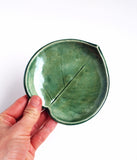 Green Leaf Bowl - SmallThis little green leaf bowl is handmade with a cream-colored clay, and is glazed with a green glaze. This bowl is perfect as a soap dish, spoon rest, jewelry dish or