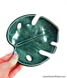 Forest green ceramic bowl, shaped like a Monstera leaf. 