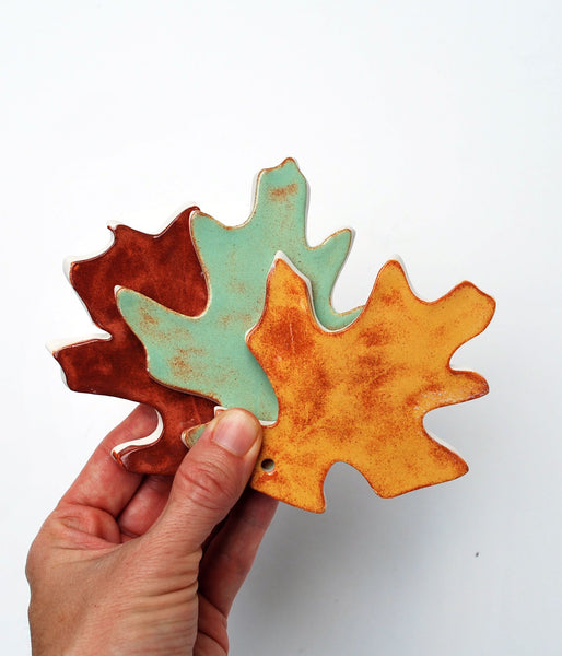 Oak Leaf OrnamentHandmade ceramic oak leaf ornament; I use a real oak leaf to create this one-of-a-kind ornament. Add metallic gold luster for a special shine on your tree.
:::::::::