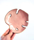 Pink and Gold Monstera Leaf Bowl - SmallMonstera Leaf Bowl :: Philodendron Leaf Dish :: Jewelry Storage :: Soap Dish :: Key Holder
This little leaf bowl is handmade with a cream-colored clay, and is glazed