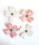 Four dogwood shaped ornaments, in white and pink glazes