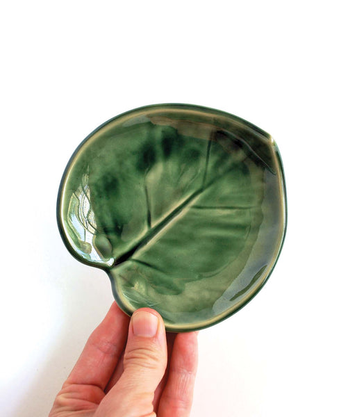 Handmade ceramic monstera-leaf shaped leaf. In brigh green glaze