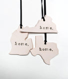 Home State Ornament. Handmade porcelain ornament in the shape of a state of your choice. The word "home" is stamped in black. 