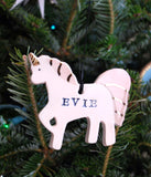 Unicorn Ornament, PersonalizedA unique and special way to celebrate the holidays. This personalized unicorn ornament is glazed white, with purple, pink, or aqua accents and gold details. Add a fi